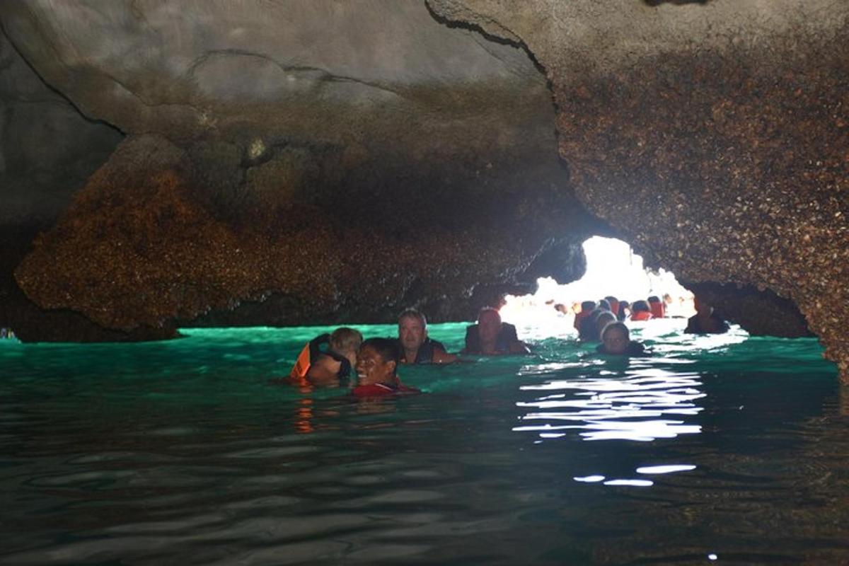 a group of people in the water in a cave