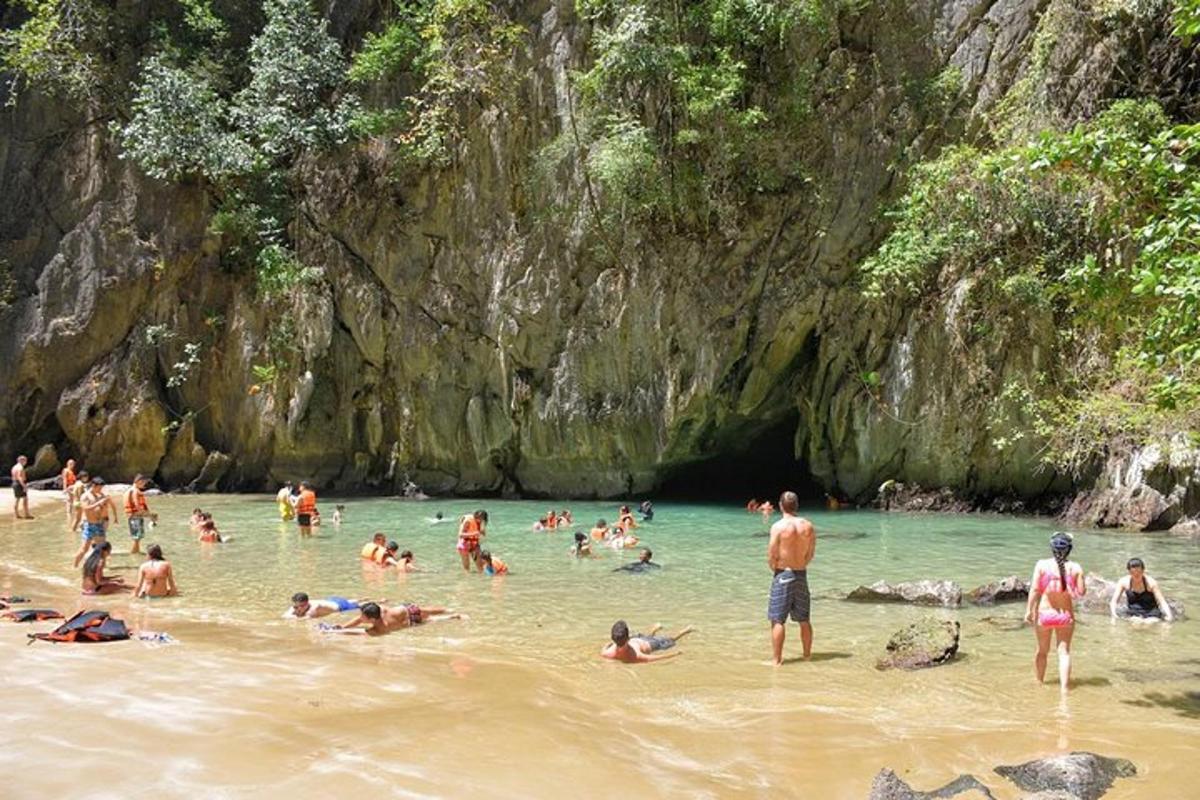a group of people in the water at a beach