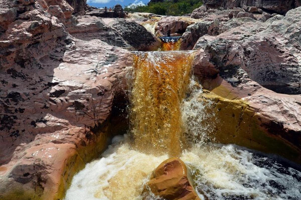 a waterfall in the middle of a rocky mountain