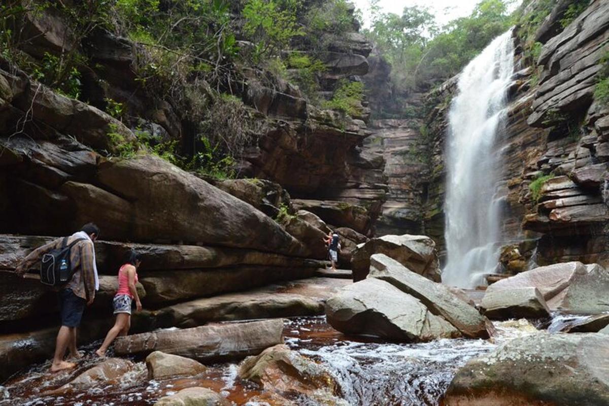 a group of people standing in a waterfall