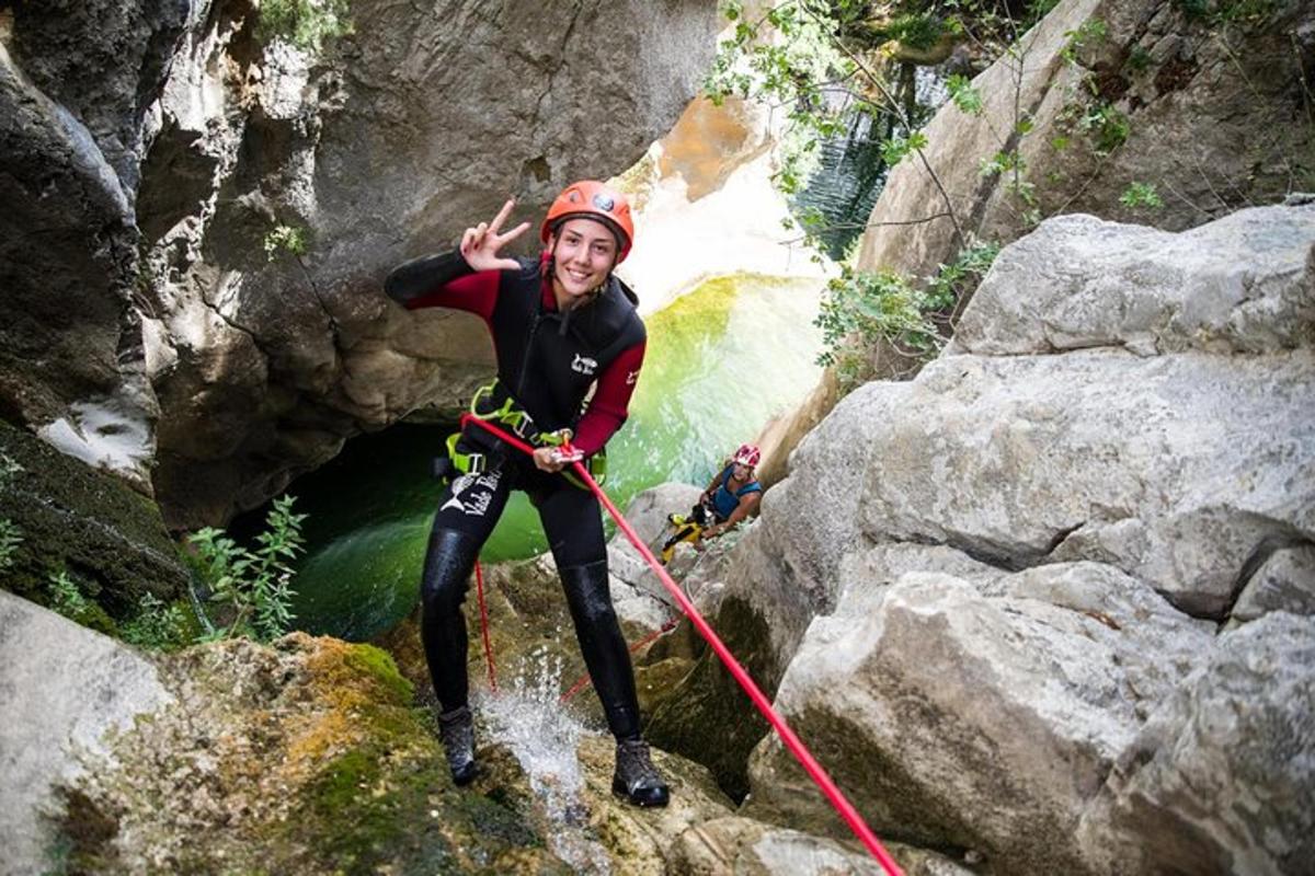 un home dret sobre una roca en una cascada