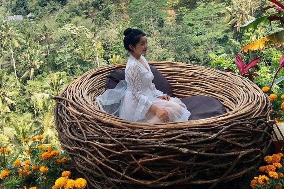 a woman sitting in a basket in a field