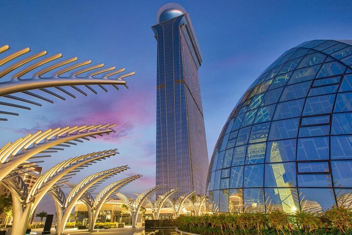 a tall building in front of a building with a fountain