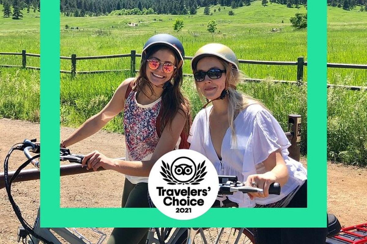 two women riding a bike with a sign on it