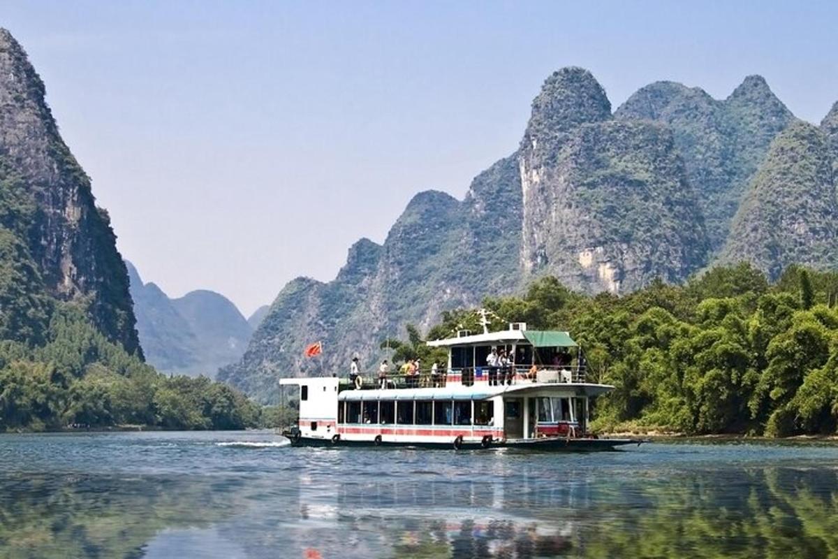 a boat on a river with mountains in the background