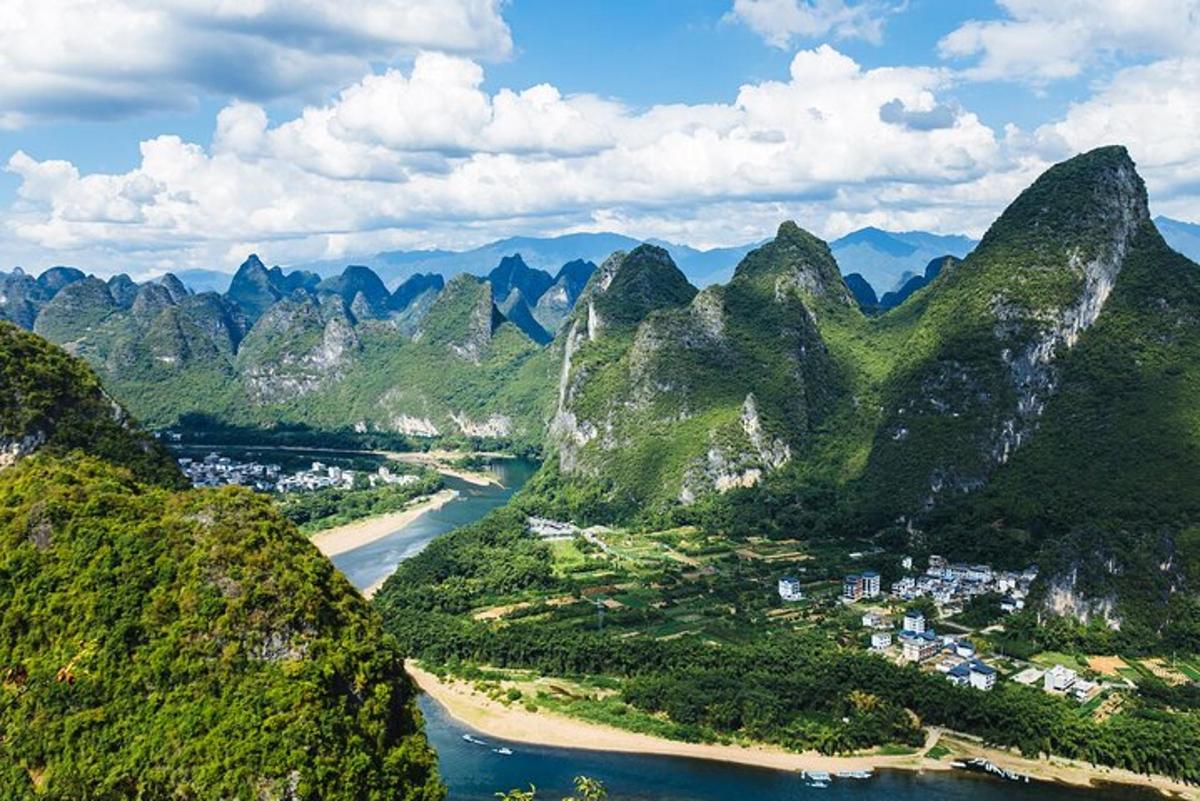 an aerial view of a river between two mountains