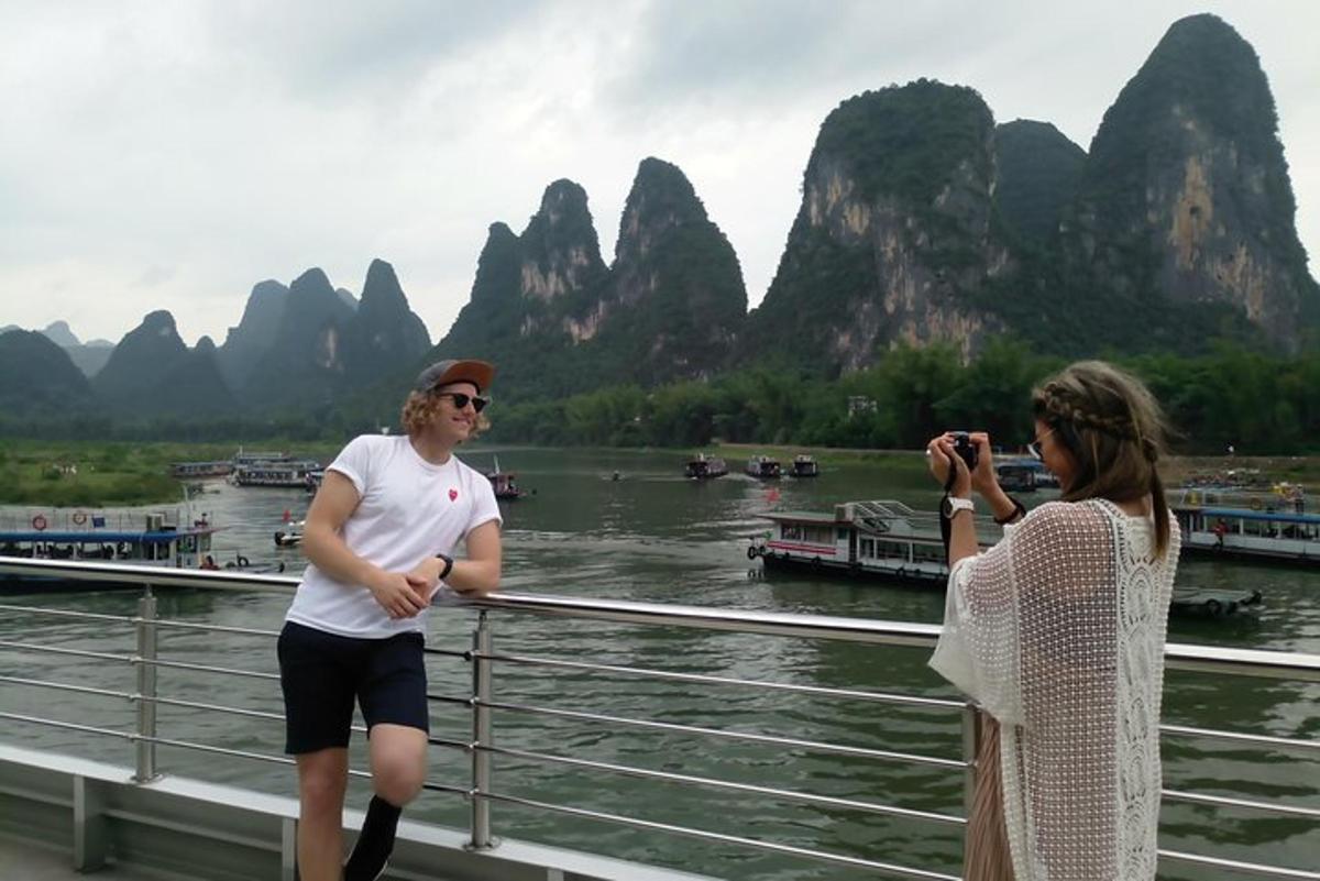 two women taking a picture of the li river