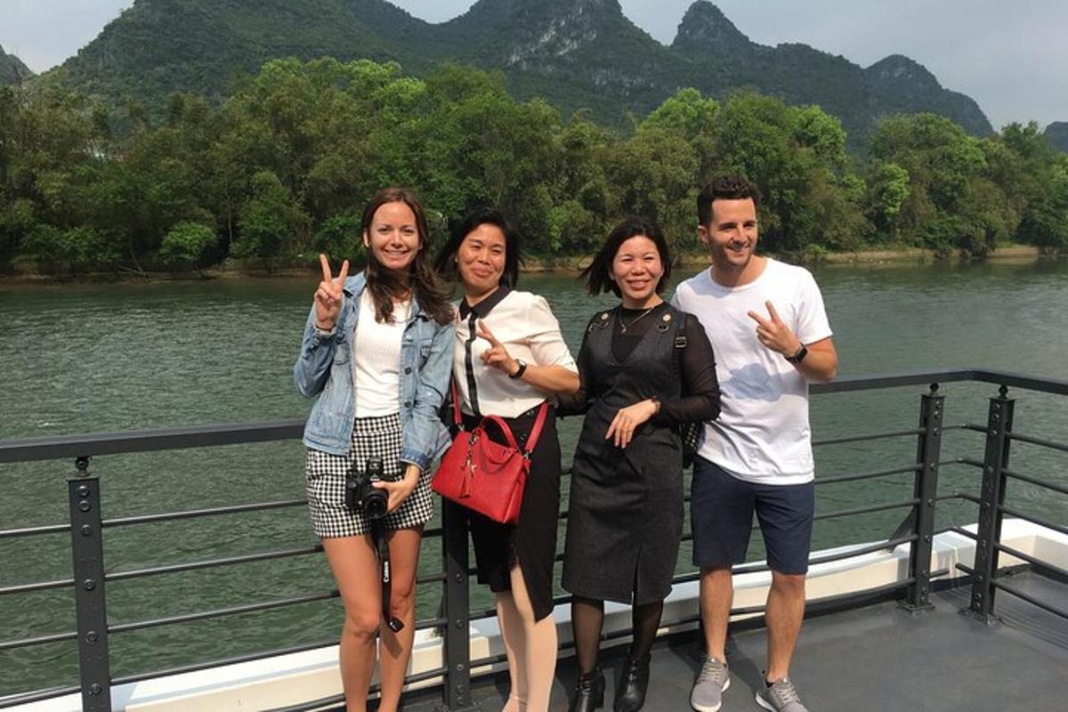 a group of people standing on a bridge near a river
