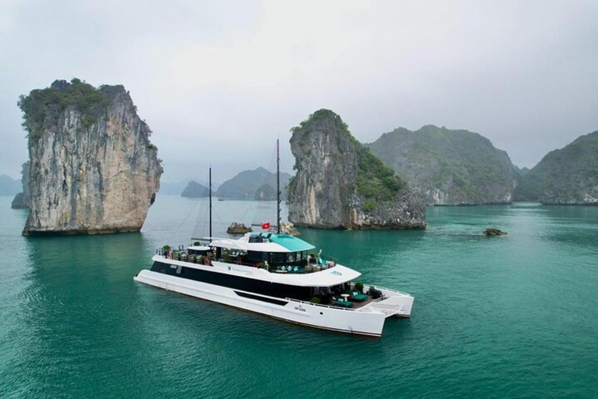 a boat floating in the water near some cliffs