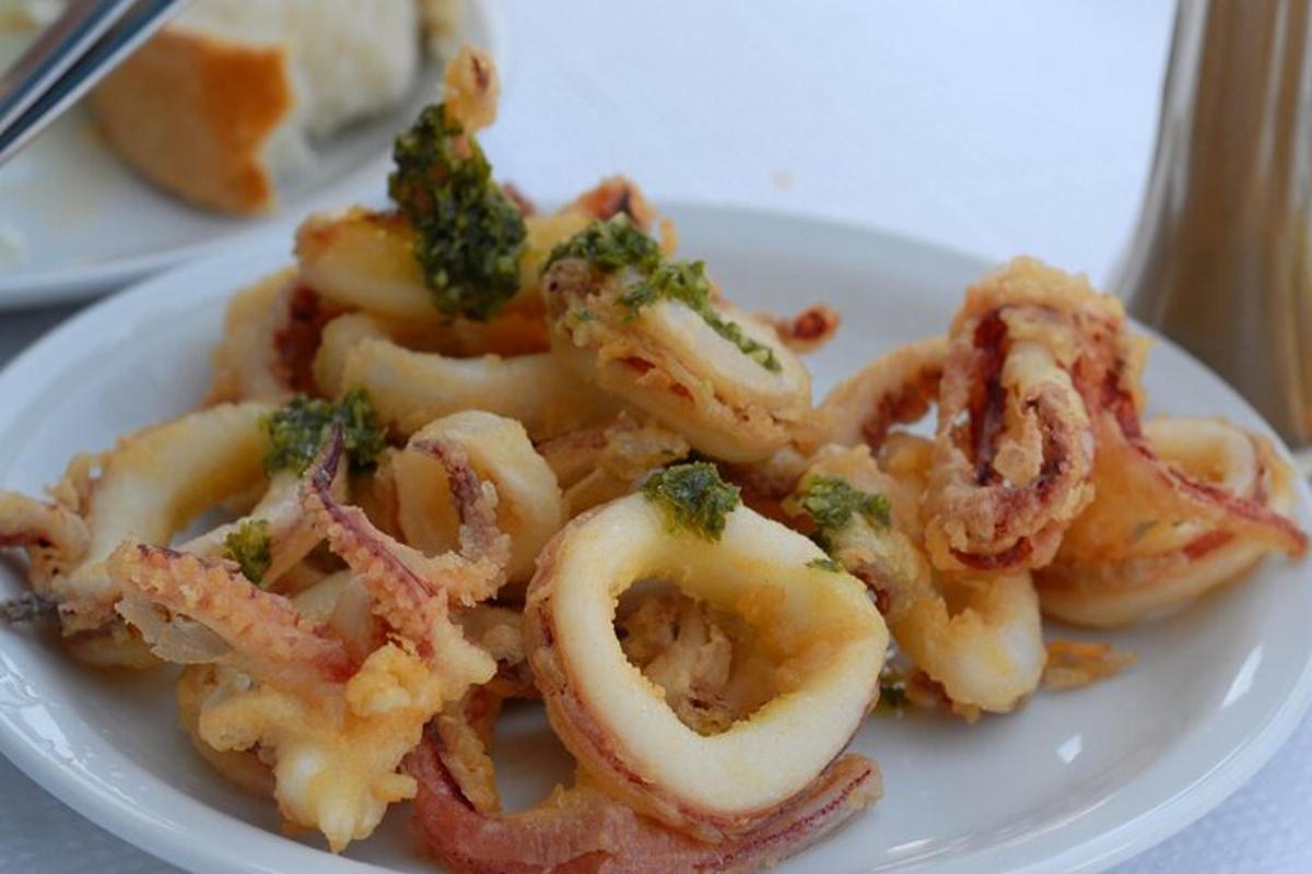 a white plate of food with shrimp and broccoli