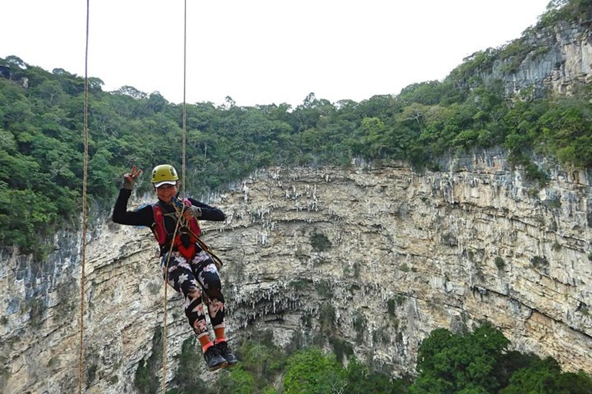 a man on a rope swing on a cliff