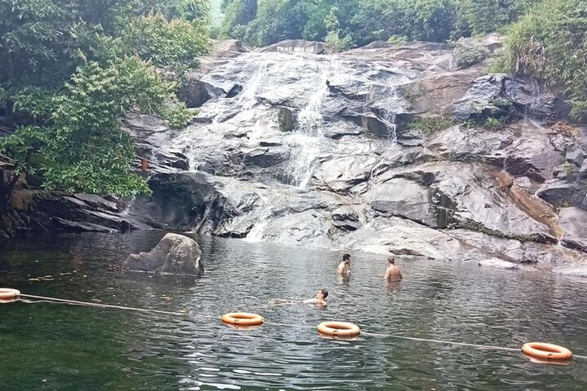 sekumpulan orang di dalam air berhampiran air terjun