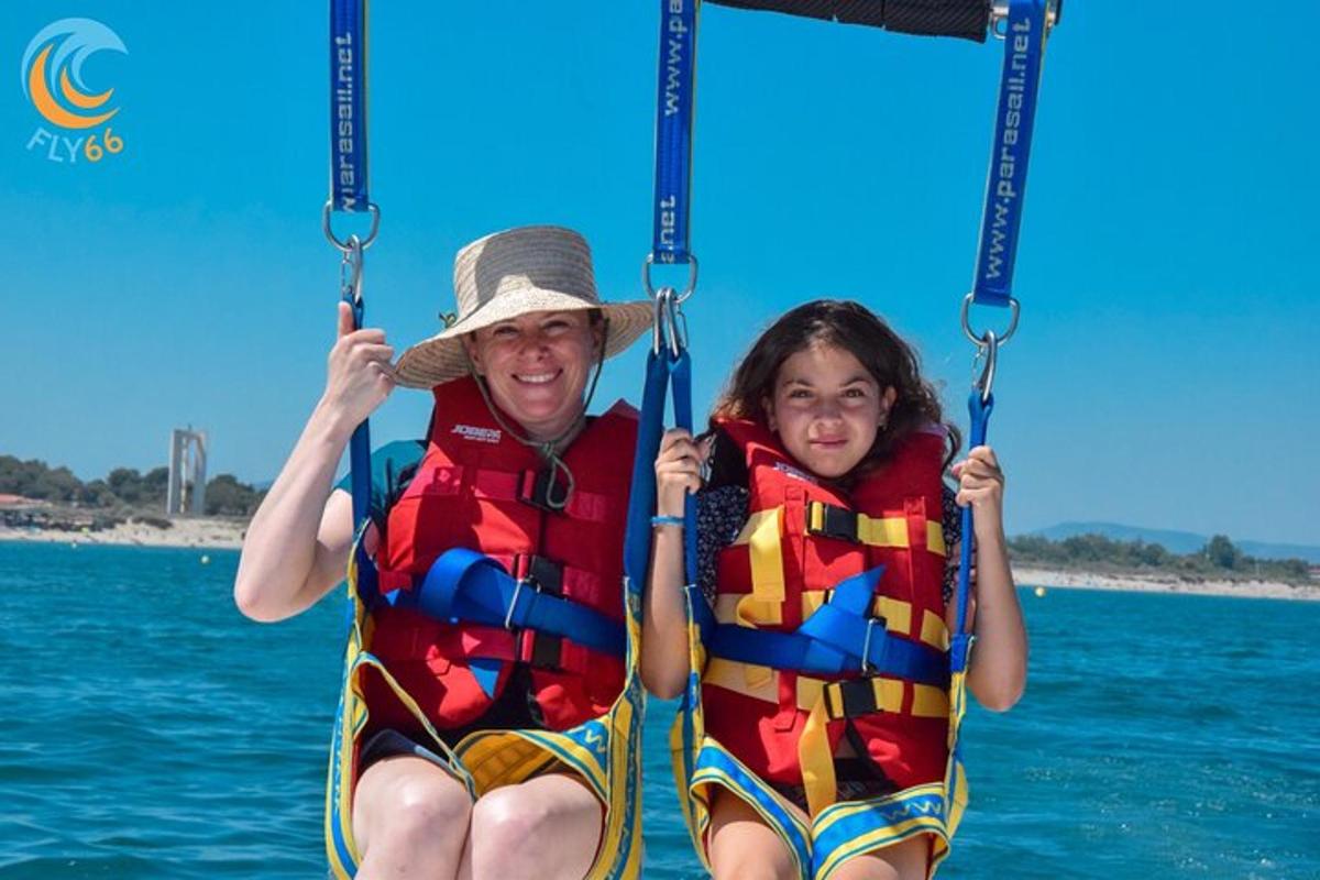 a man and a girl riding on a swing in the water