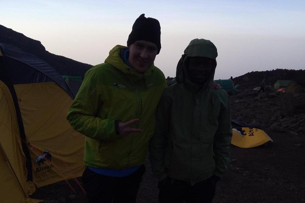 two people standing in front of a tent