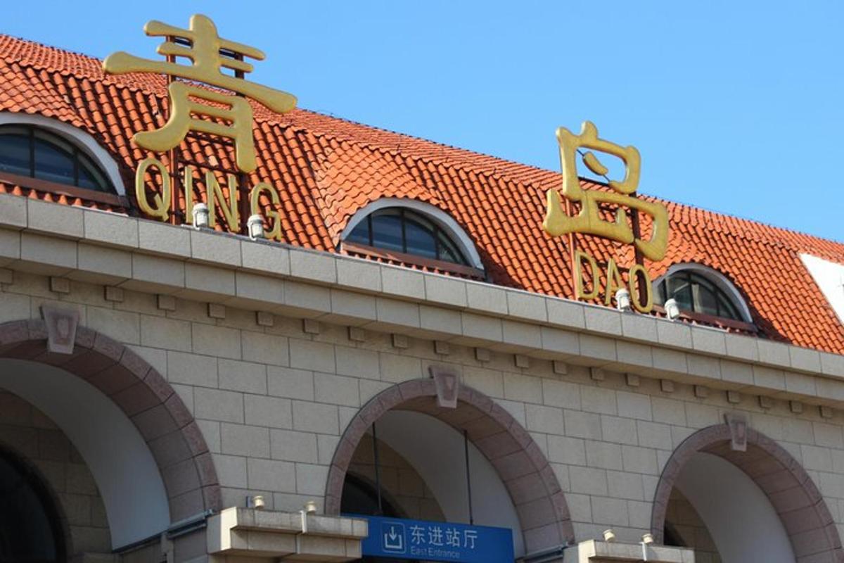 a building with an orange roof with chinese signs on it