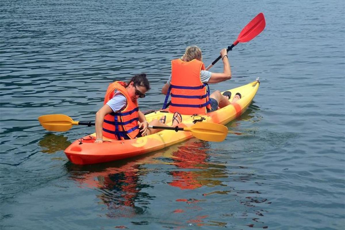 two people in kayaks on a body of water