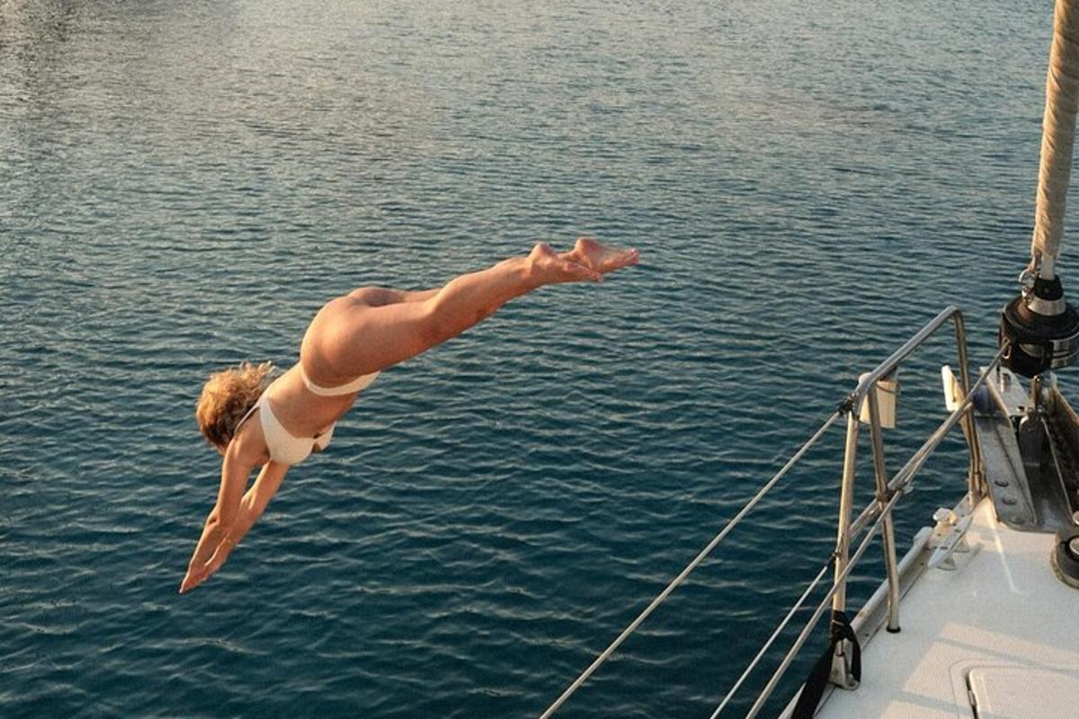 a man jumping off of a boat into the water