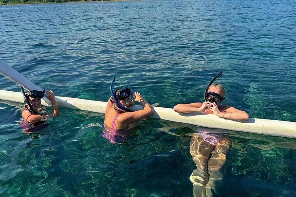 a group of people in the water on a boat