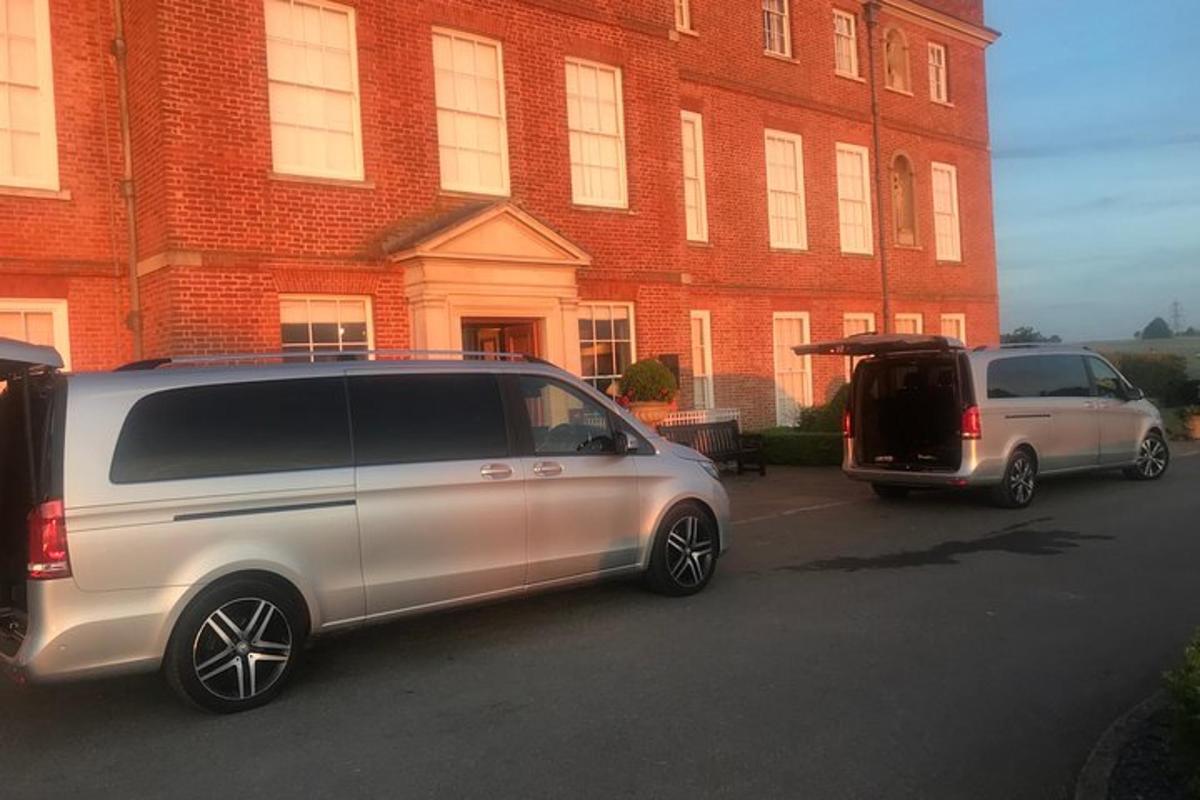two cars parked in front of a brick building