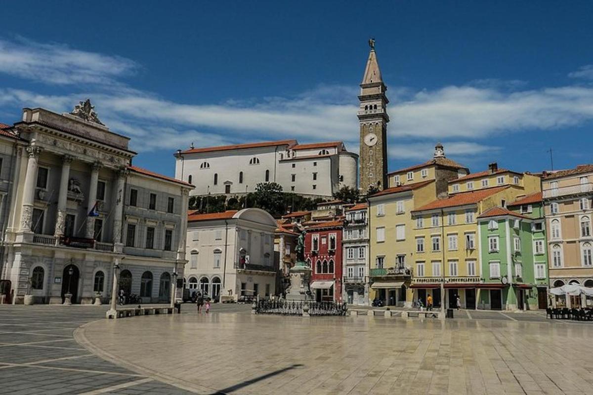 a city square with a clock tower and buildings