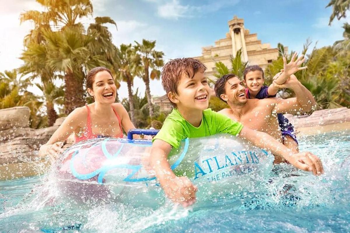a group of children playing in a pool at a resort