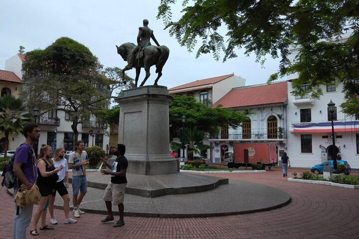 a group of people standing in front of a statue