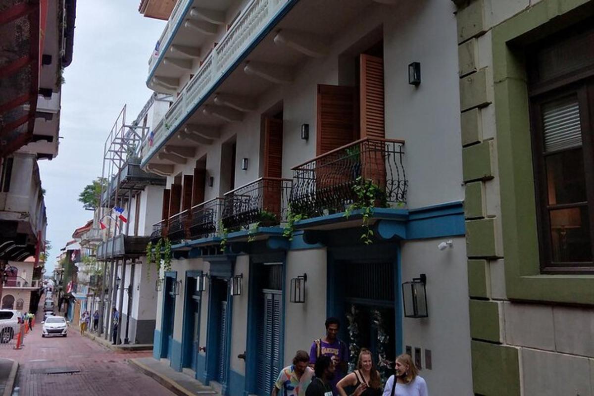 a group of people walking down a street next to a building