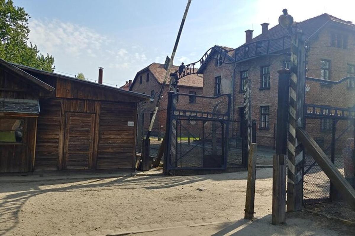 an open gate to a building with a barn