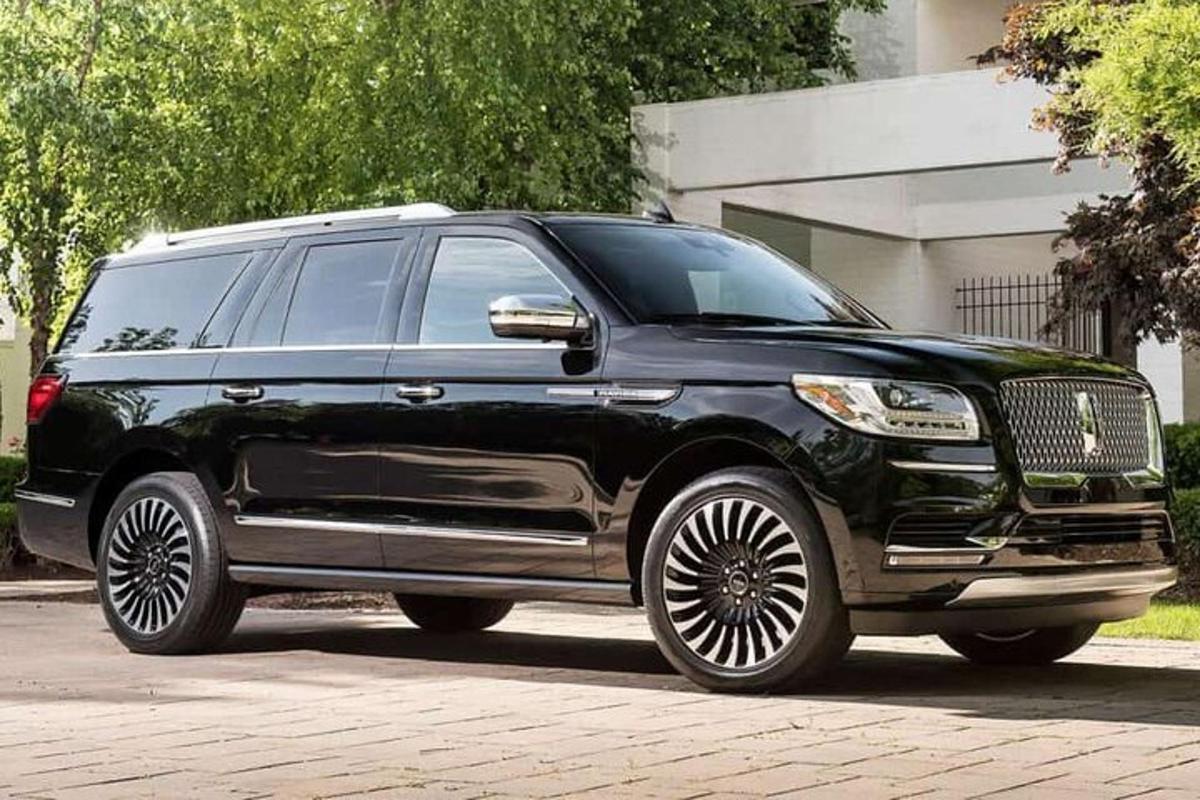 a black limousine parked in a driveway
