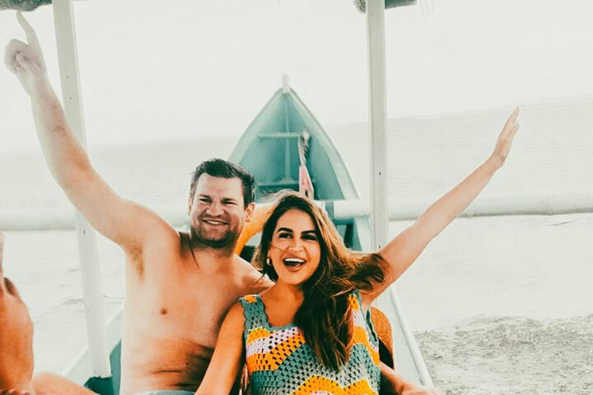 a man and a woman sitting on a beach