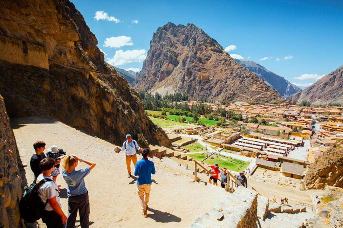 a group of people looking at the ruins of a mountain