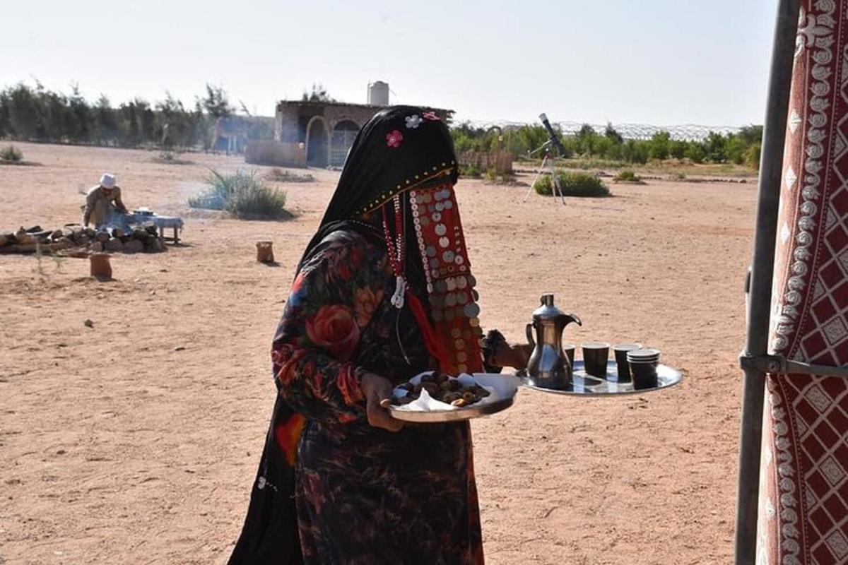 a woman holding a plate of food in a desert