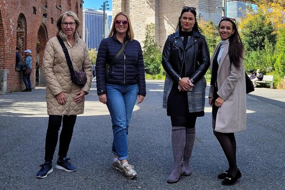 a group of three women standing in the street