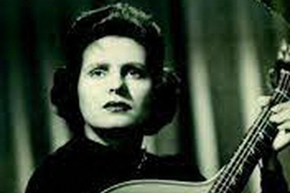 a woman with headphones playing a guitar