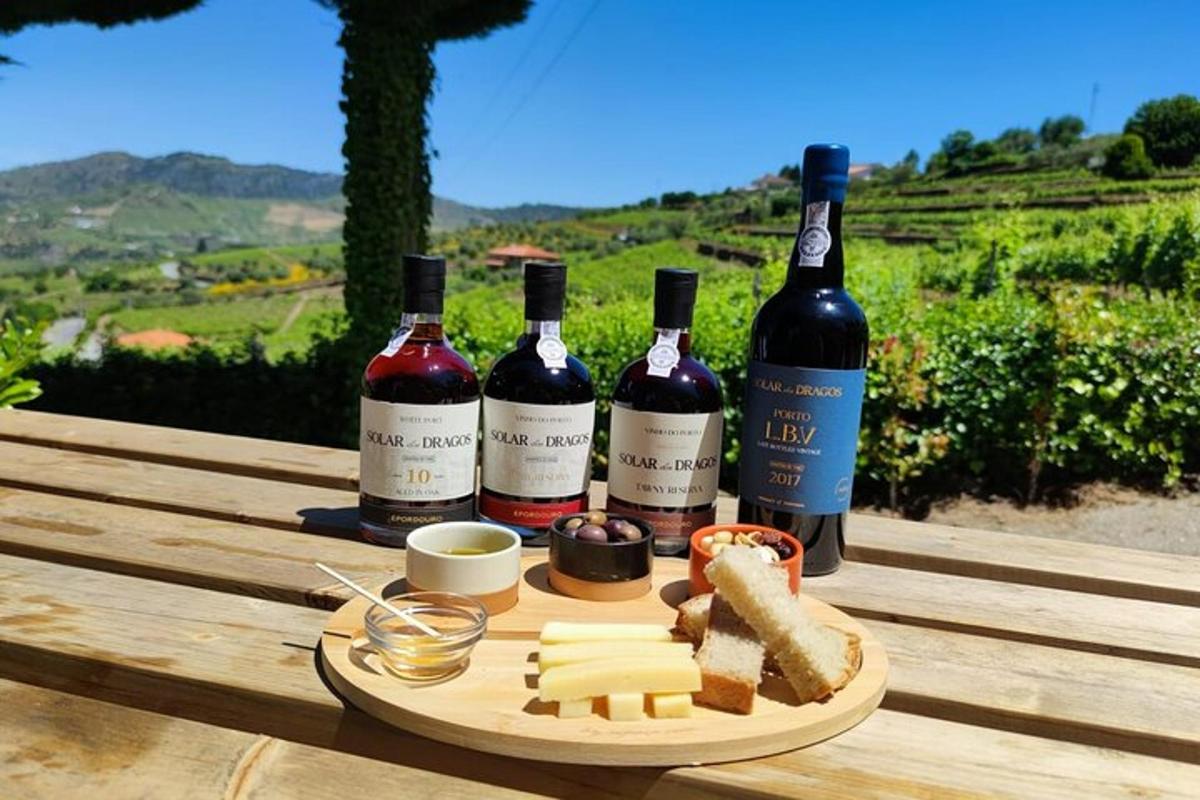 three bottles of wine and cheese on a wooden table