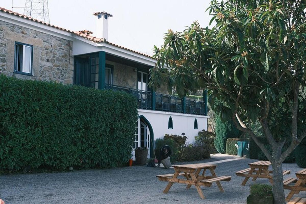 two wooden picnic tables in front of a building