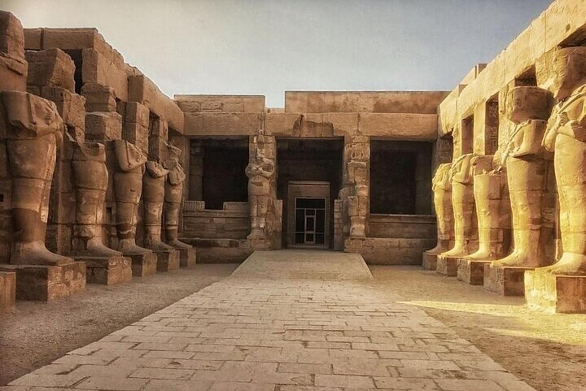 a building with a hallway with columns and a door