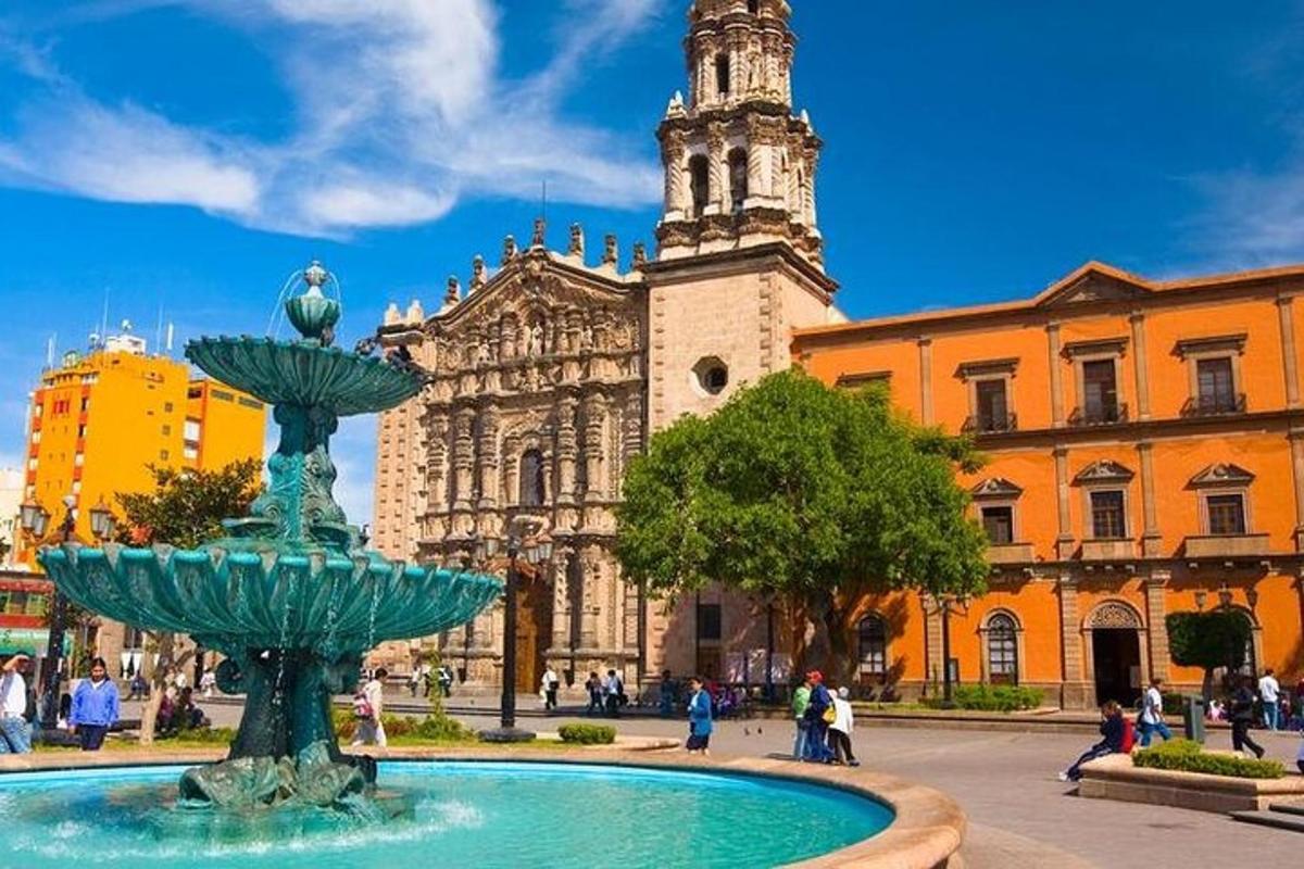 a fountain in front of a building with a church