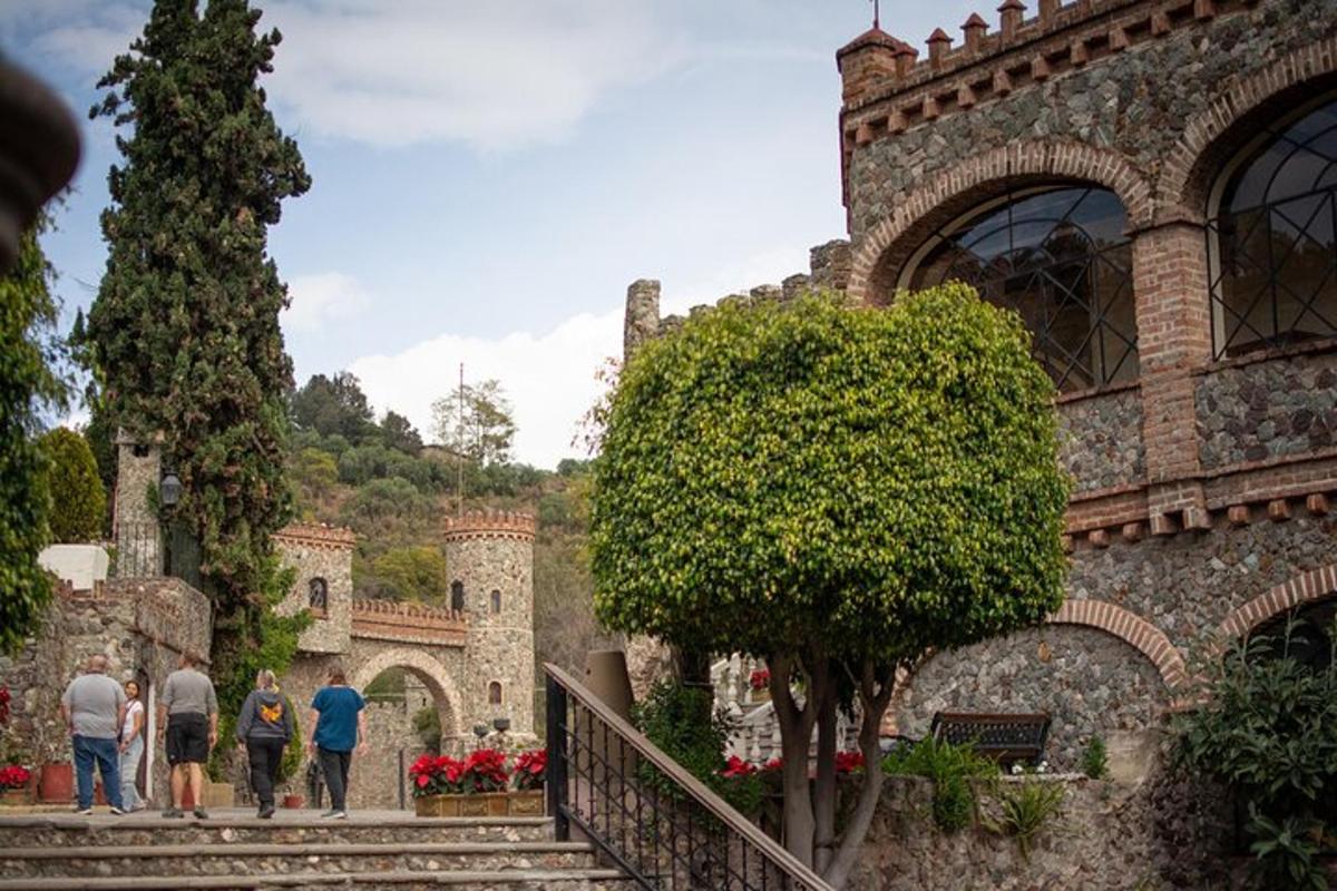 people walking up the stairs of a castle
