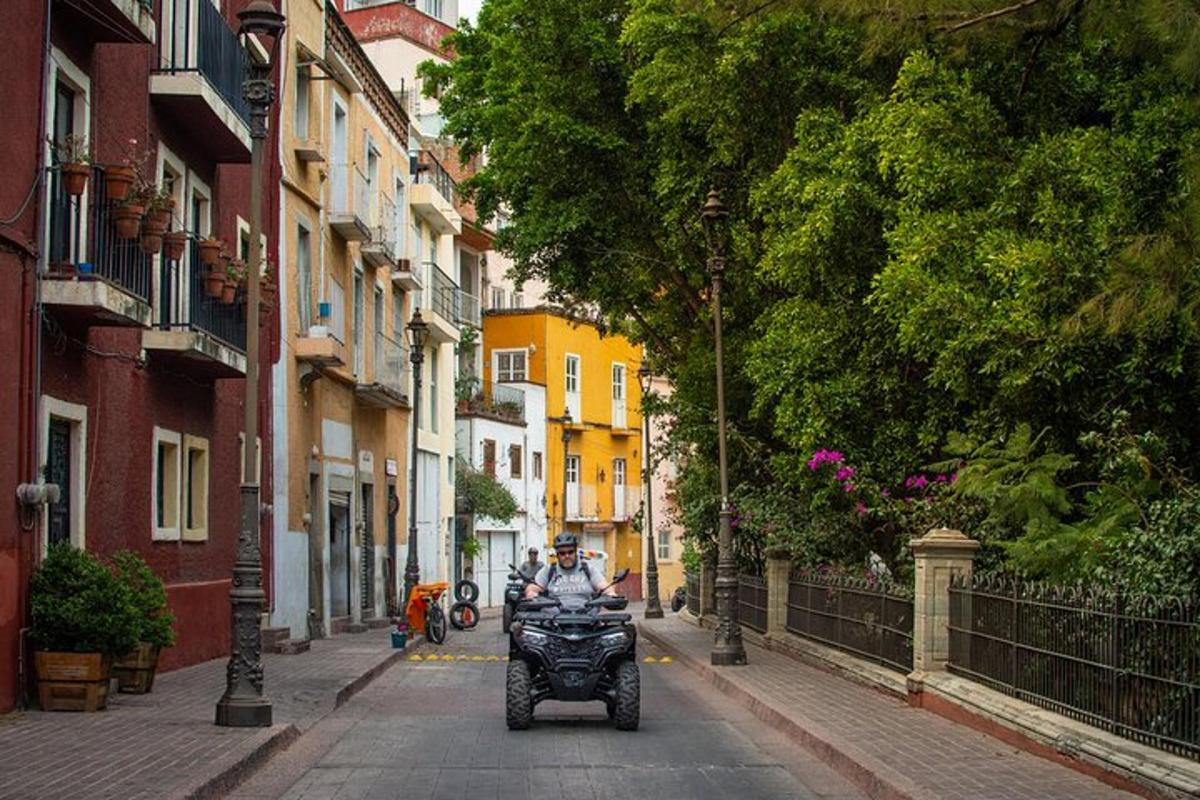 a man riding a motorcycle down a city street