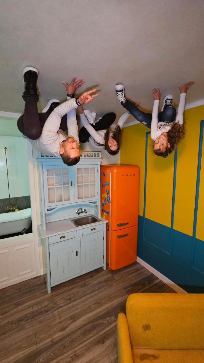 a group of people jumping off the ceiling of a kitchen