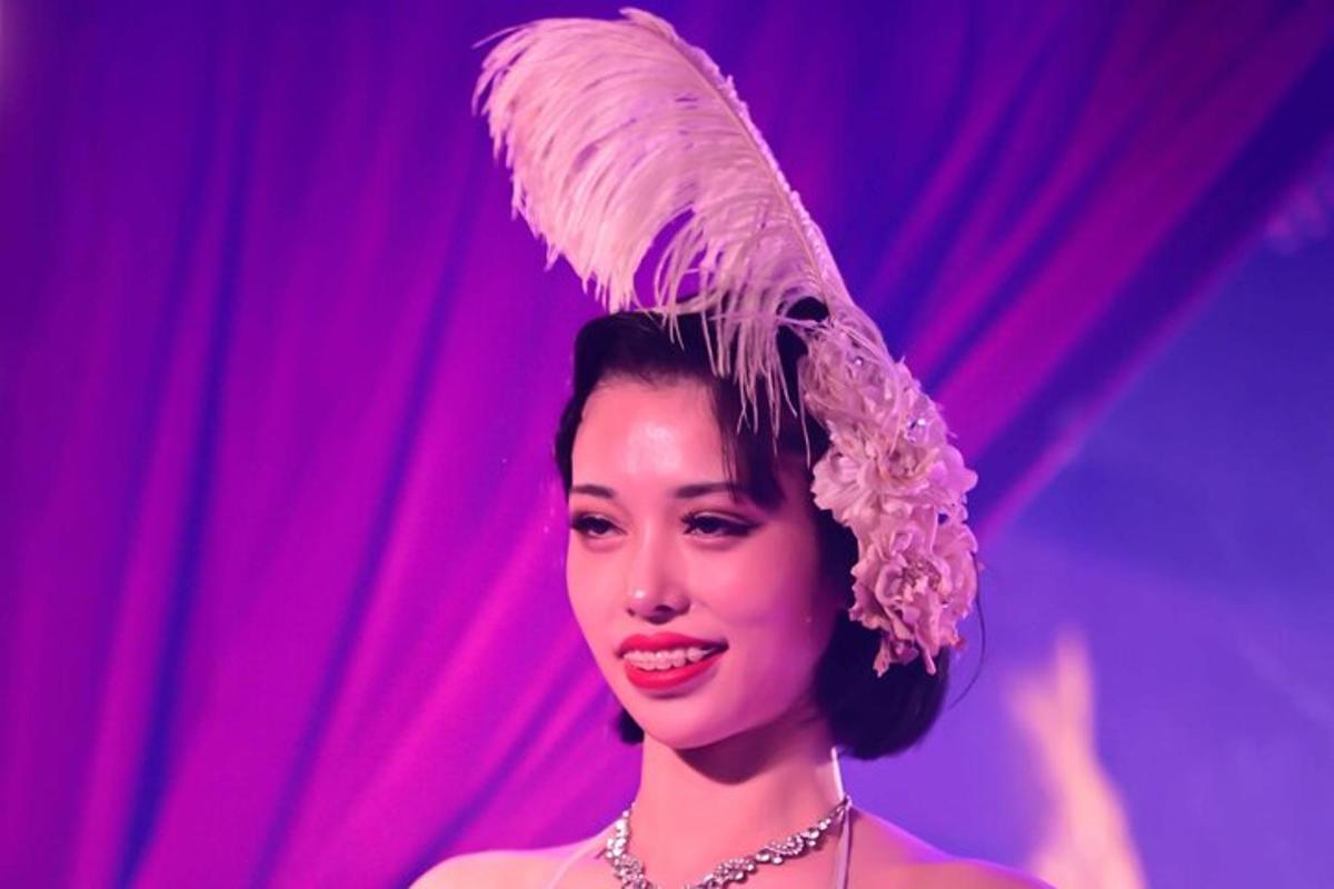 a woman is wearing a hat on a stage