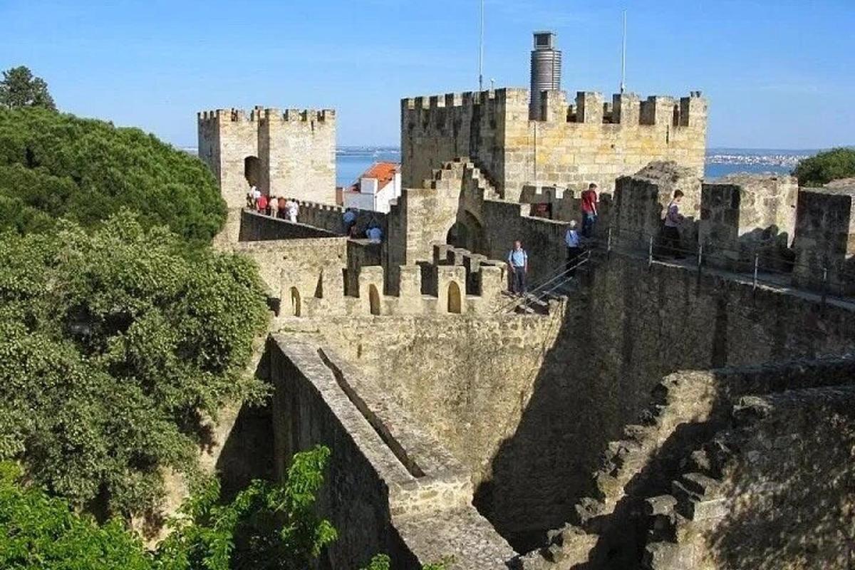 hrad na vrcholu kopce s lidmi, kteří po něm chodí