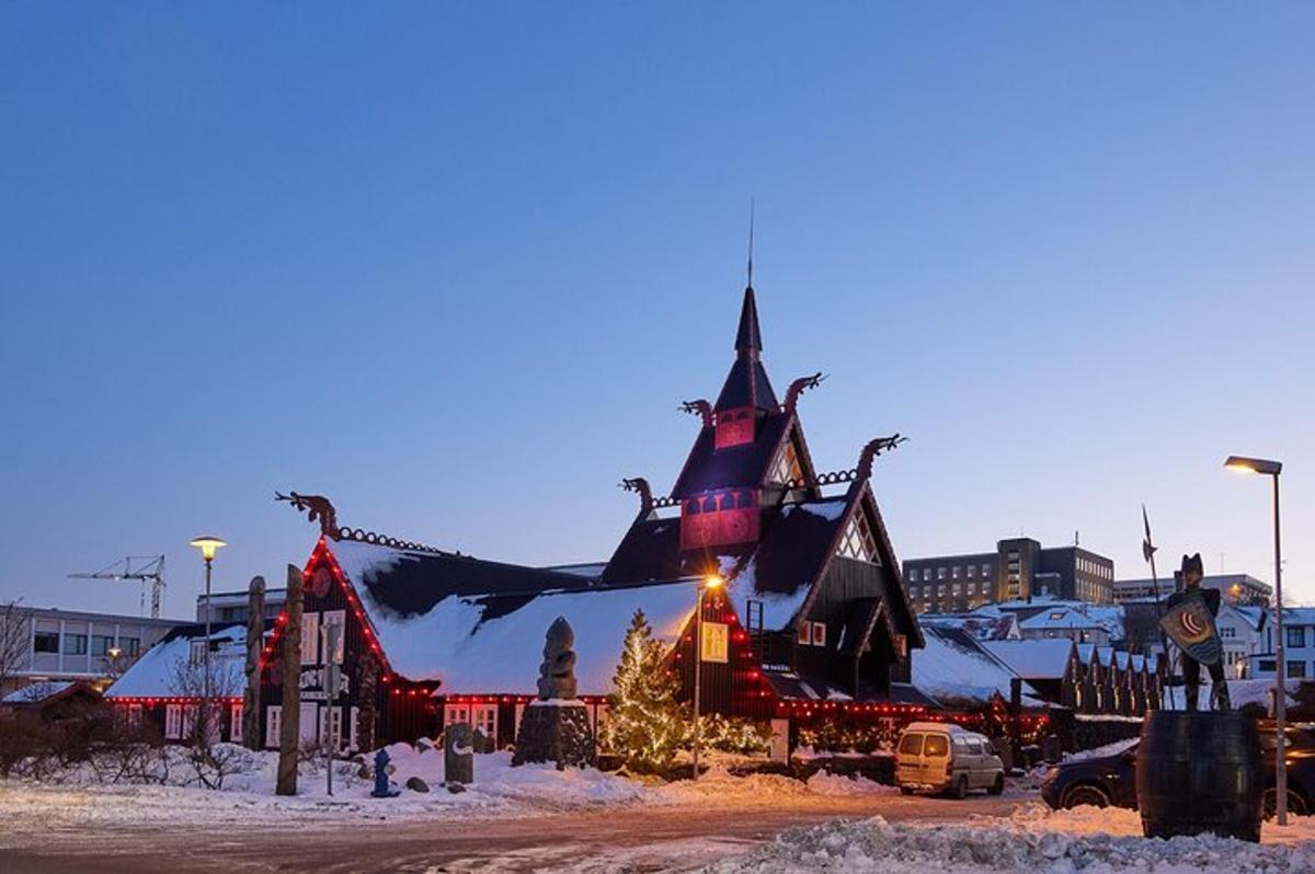 a large building with a christmas display in the snow