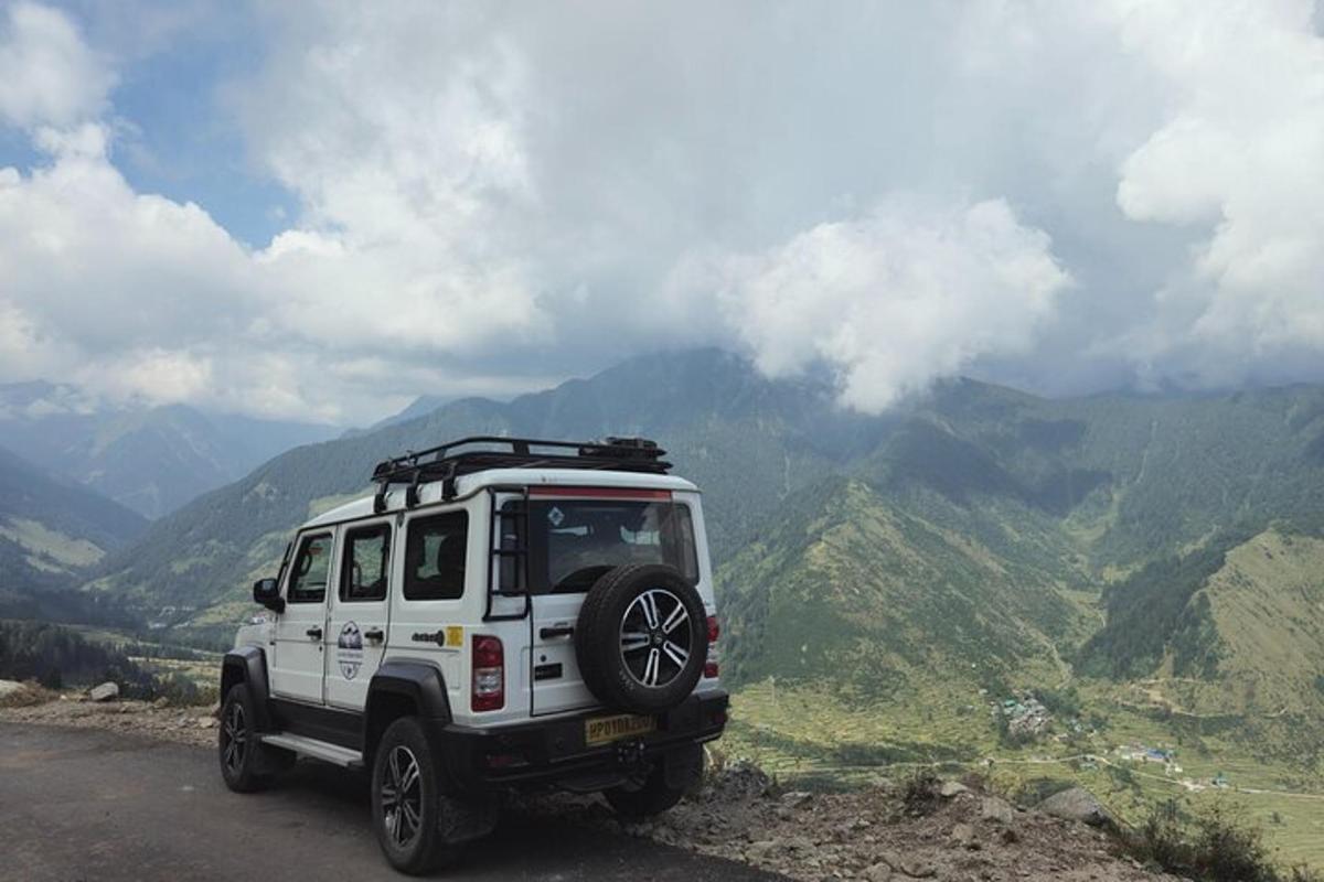 a white jeep parked on the side of a mountain