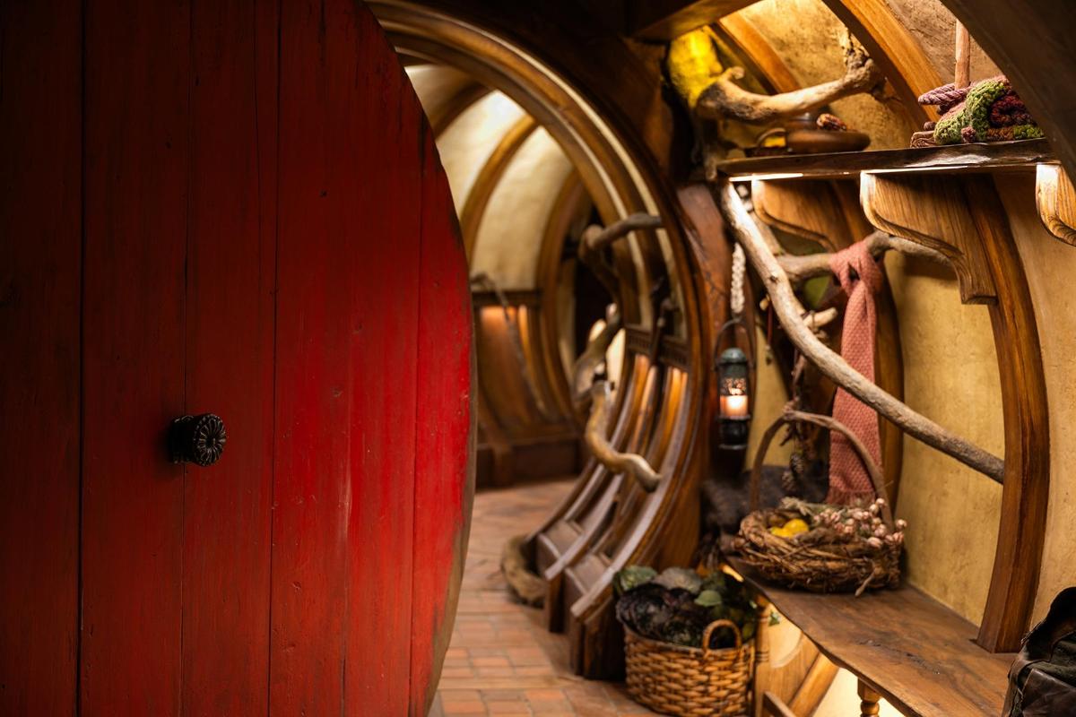 a red surfboard is in a room with barrels