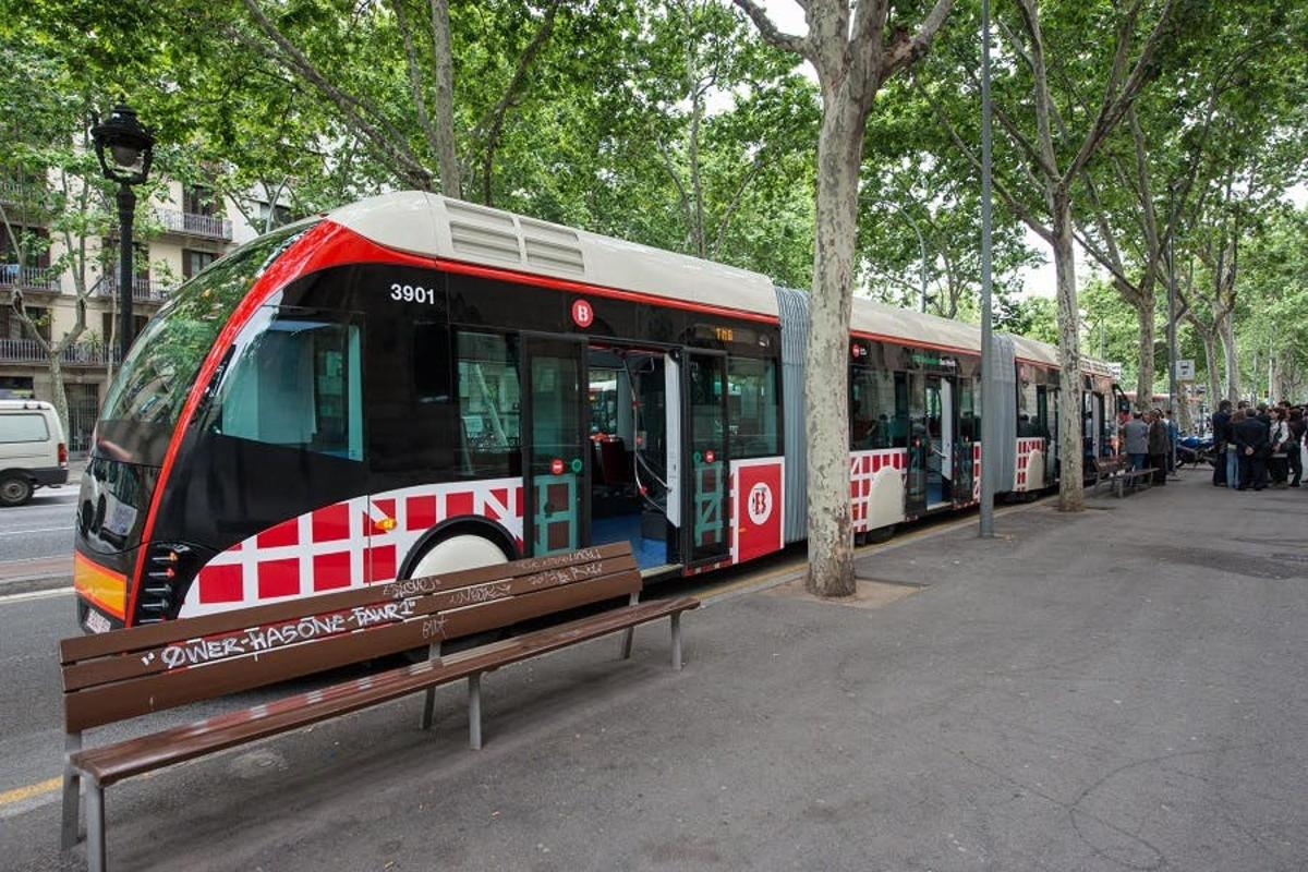 a bus parked at a bus stop next to a bench