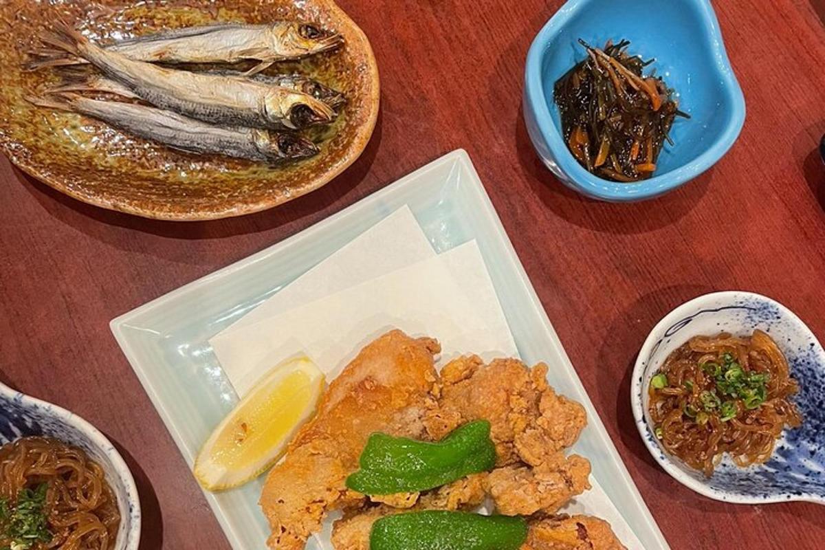 a table with a plate of food and some fish