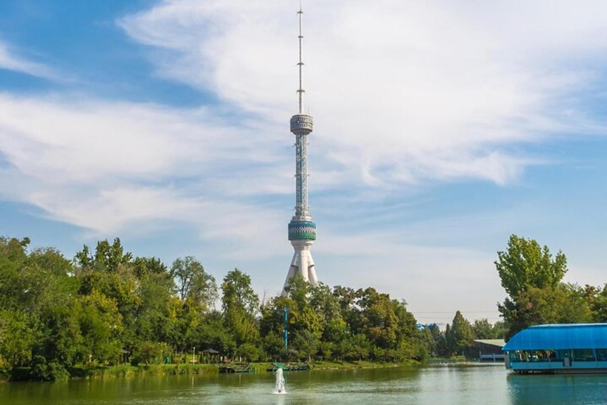a tv tower in the middle of a river with a bus