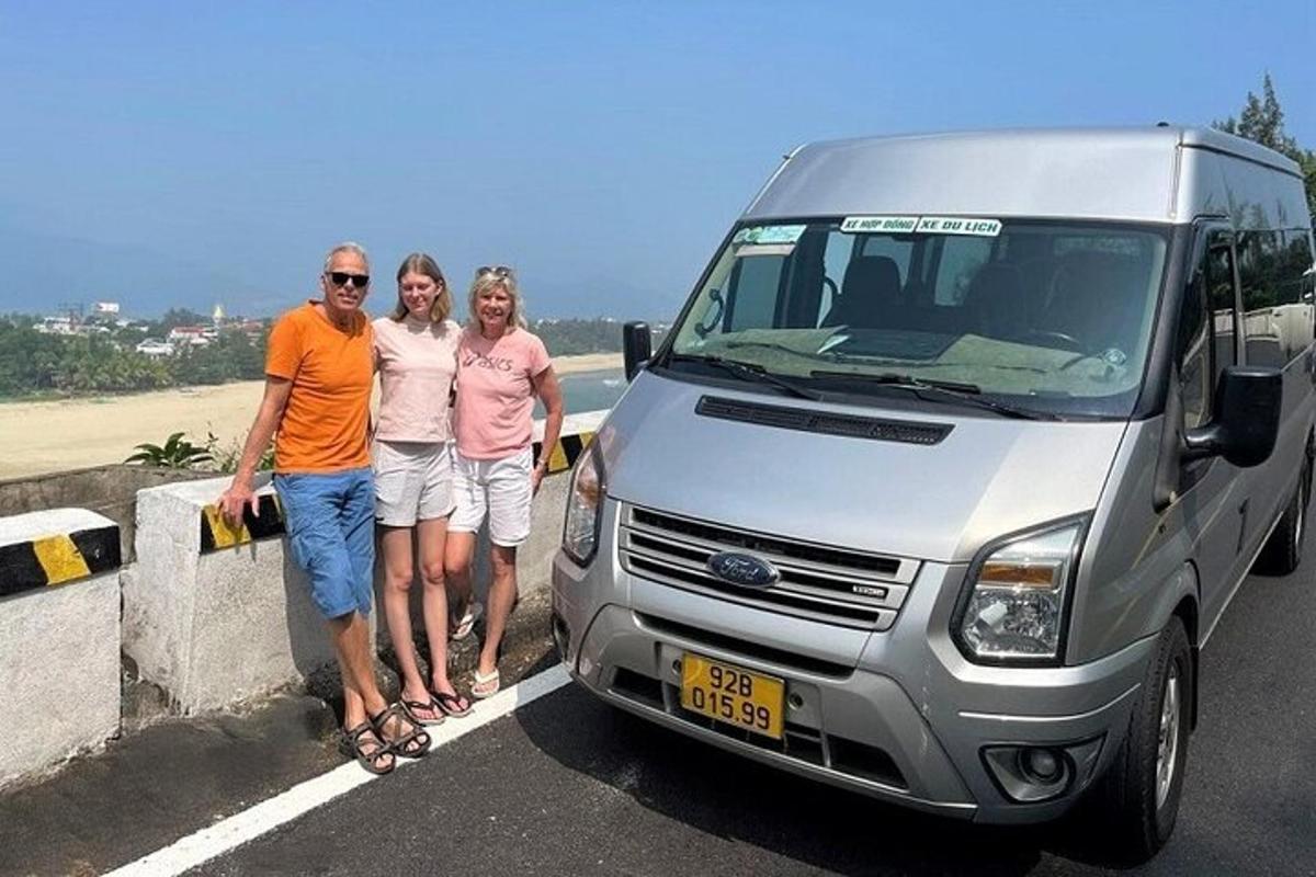 a group of three people standing next to a van